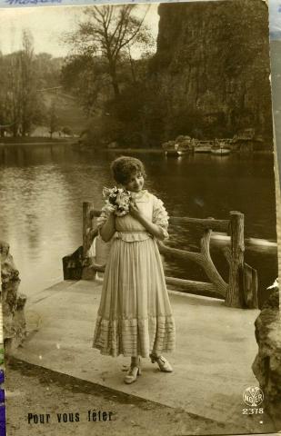 Sepia photo of woman with flowers.