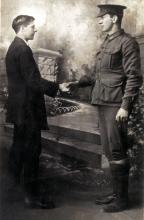 Black and white photo of William and Thomas shaking hands. 