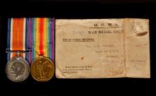Picture of two war medals alongside it's envelope.