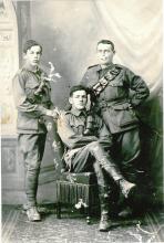 Black and white photo of three soldiers in uniform.